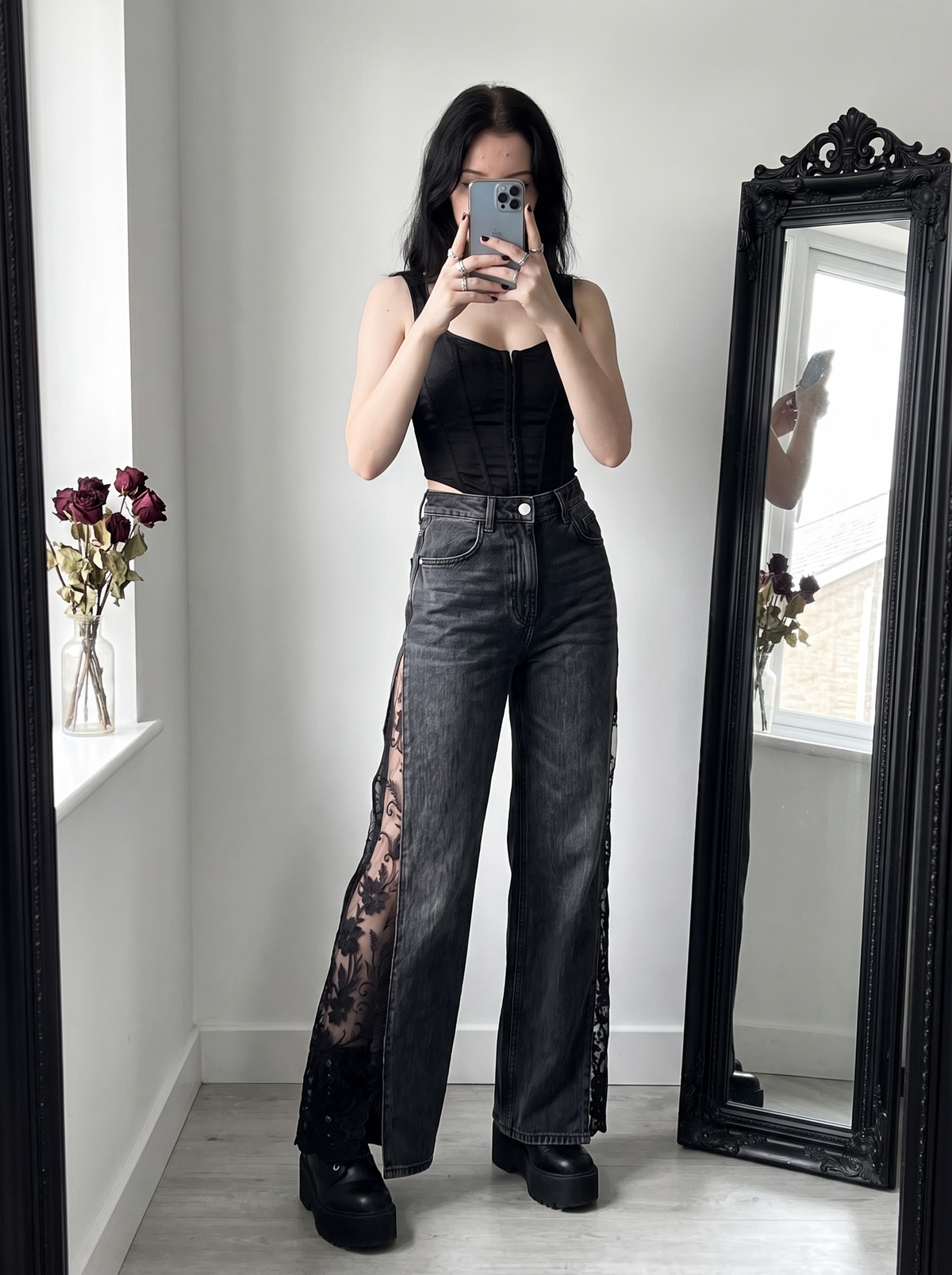 Raven Lace Jeans in black styled with a corset top and platform boots, mirror selfie